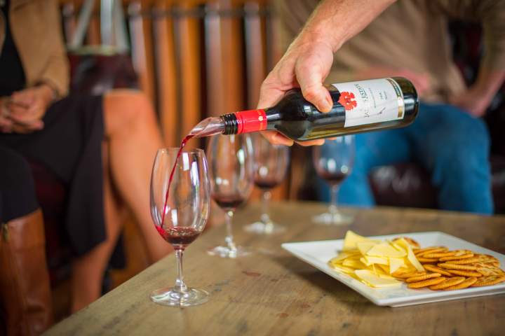 a person sitting at a table with a glass of wine